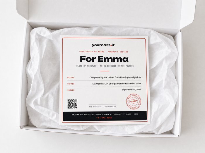 An open white gift box with the certificate resting on tissue paper